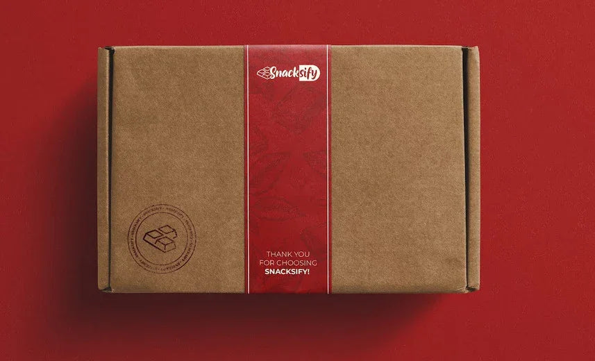 Brown cardboard box with a red label featuring 'Snacksify' on a red background Brown cardboard box with a red label featuring 'Snacksify' on a red background