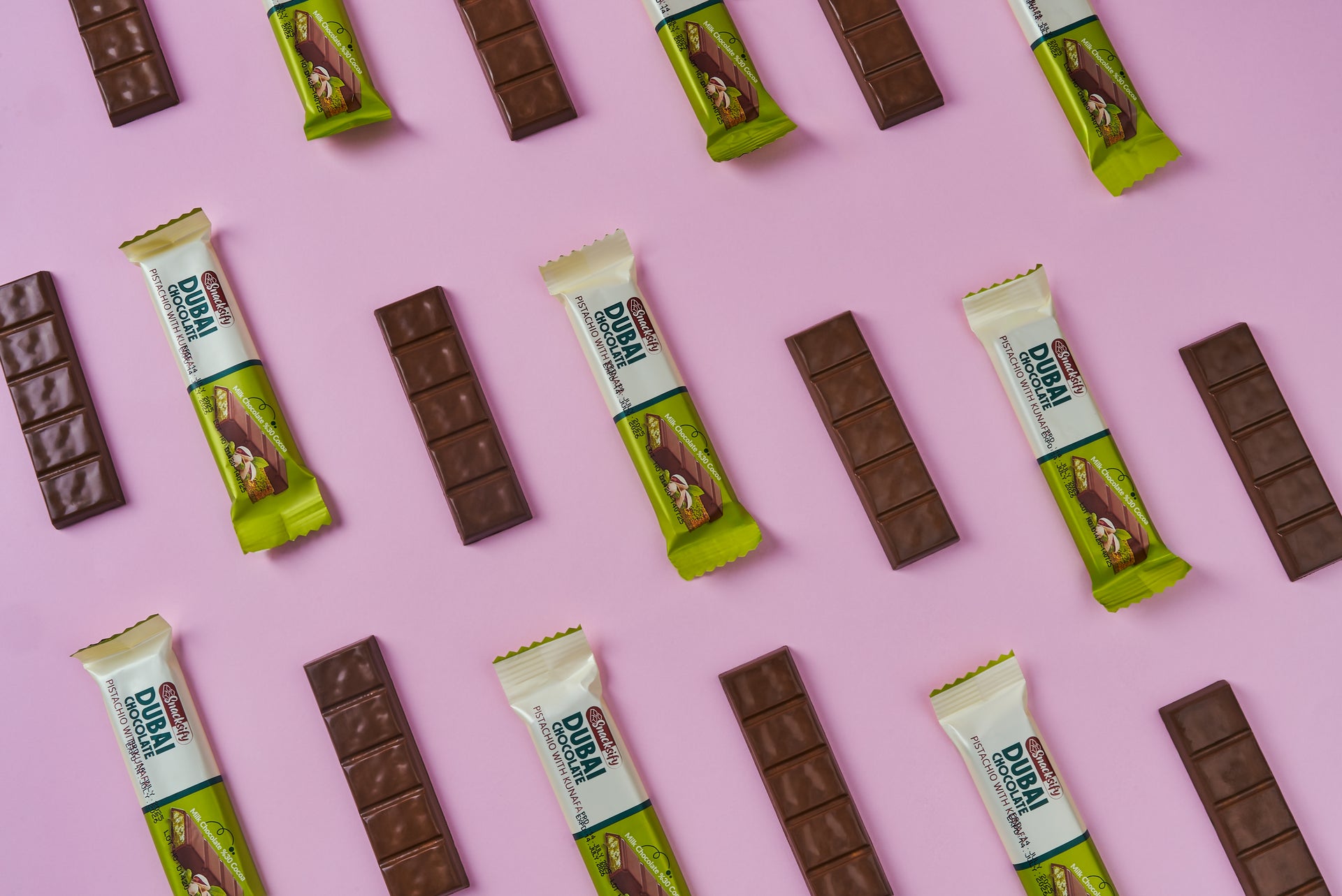 Snacksify Dubai Chocolate bars and arranged in a pattern on a pink background