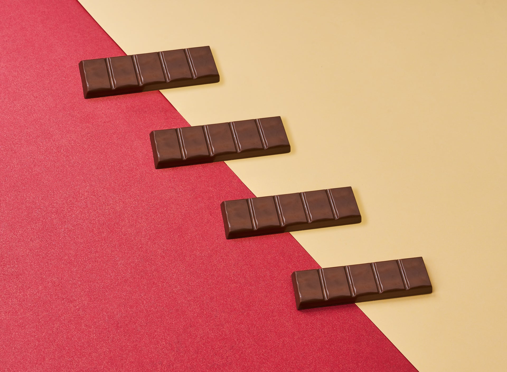 Snacksify Dubai Chocolate bars arranged in a zigzag pattern on a red and beige background